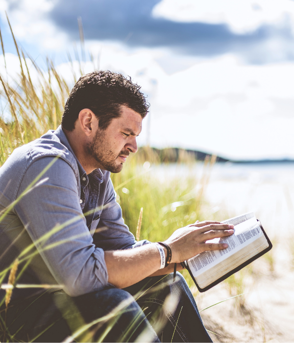 Christian counseling services provide clarity for a brighter tomorrow. A man reads his bible to connect with his faith after a Christian counseling session.
