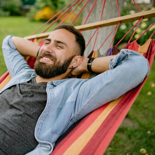A man relaxes on a hammock, illustrating that online counseling means support that meets you where you feel most at ease — because healing can happen wherever you find your calm.